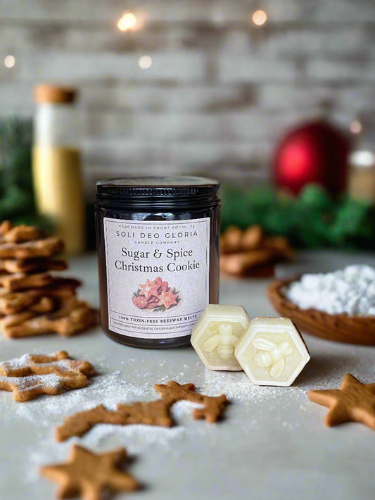 Candle labeled 'Sugar & Spice Christmas Cookie' with cookies and a festive background
